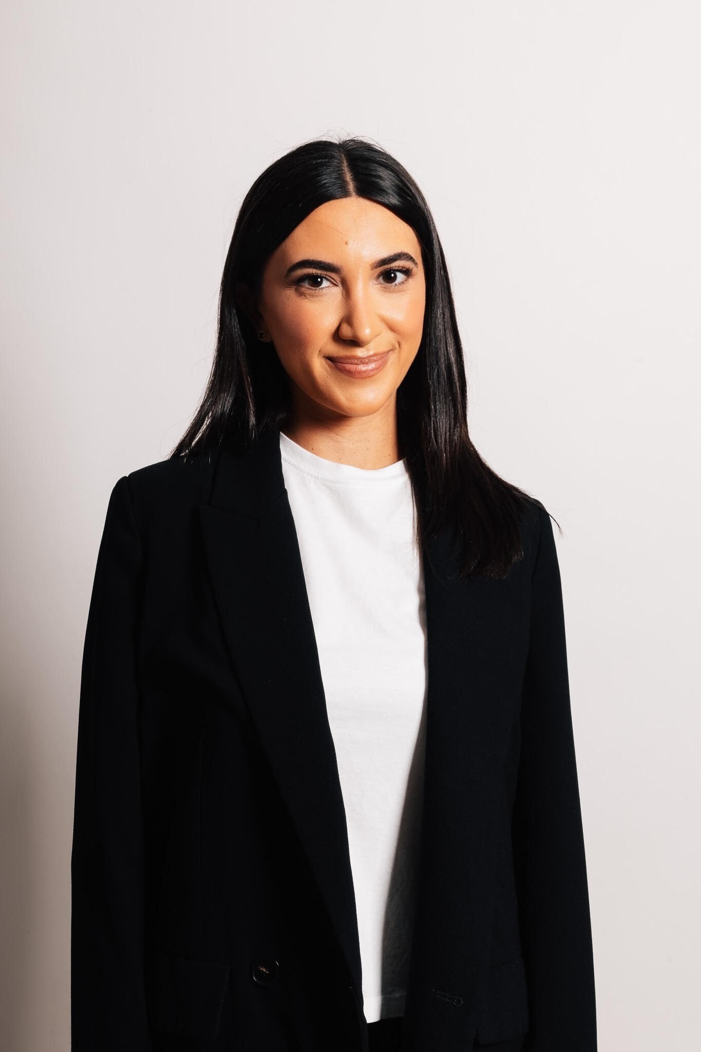 Color portrait of Dr. Milena Arakelyan in a black coat and white shirt